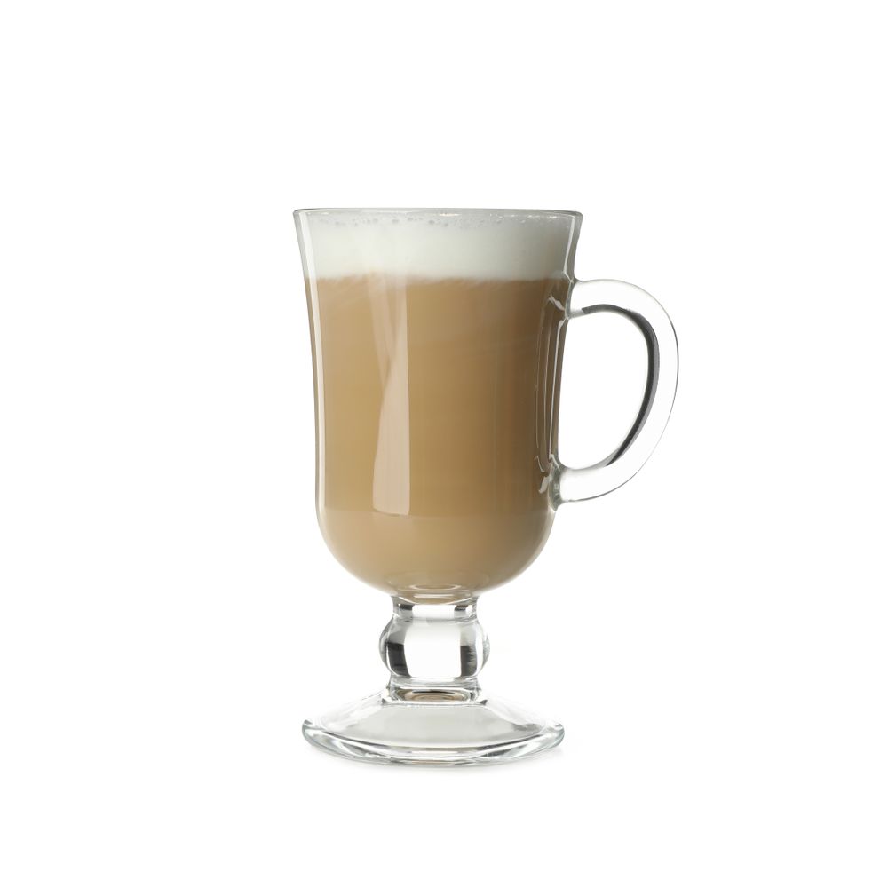 Glass cup of latte isolated on studio background