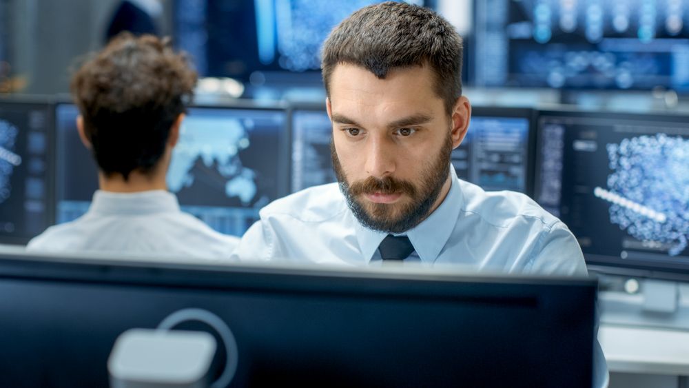Neural Network and Machine Learning Engineer Programming at His Workstation.