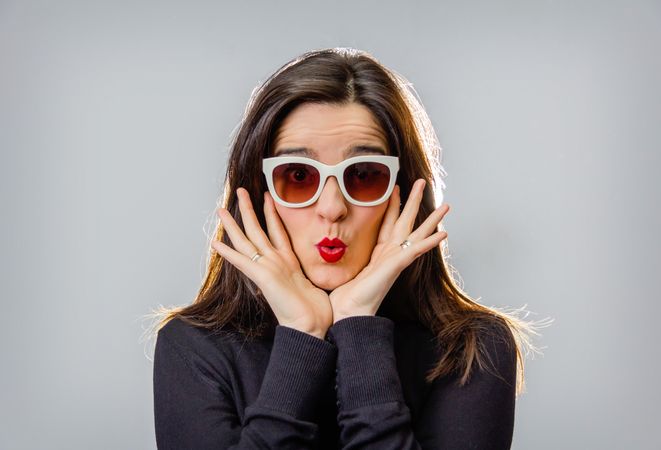 Woman with sunglasses and red lips gesturing