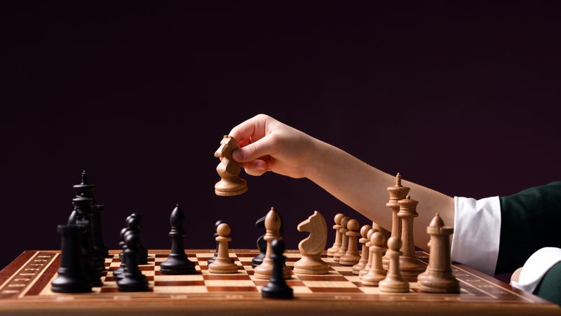 Hand with chess piece