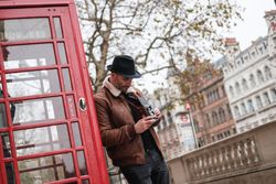 Male photographer near red telephone box