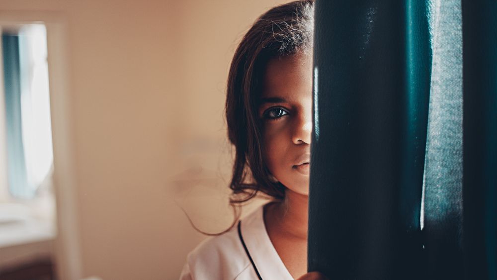 Woman leaning on curtain