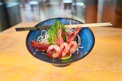 Tasty prawns on plate with chopsticks