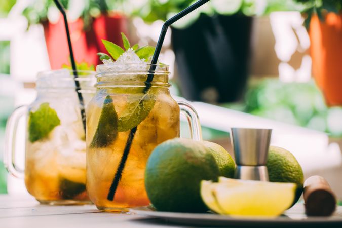 Mojito in mason jar and ingredients on wooden table
