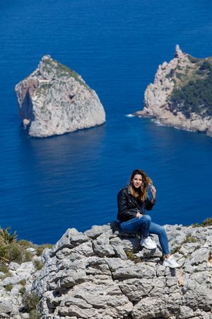 Young woman resting on cliff