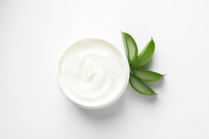 Composition with natural treatment accessories on plain background, top view and space for text. Aloe vera