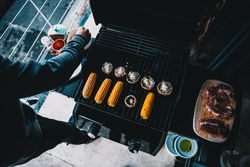 Mushrooms, corn and meat being prepared for grilling