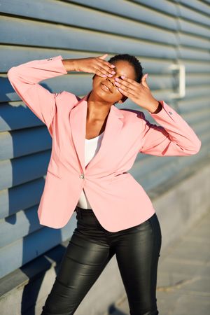 Front view of female in modern business casual with hands over her eyes
