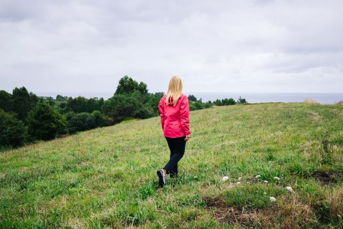 Woman standing in countryside and looking away