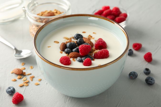 Flat lay composition with parfaits dessert and ingredients on cement background