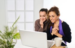 smiling friends chatting over the internet
