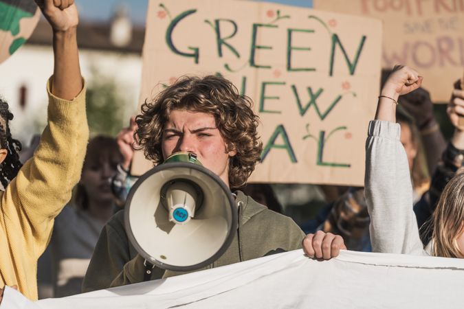 Young man with curly hair participating in an environmental protest