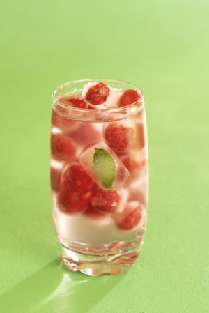 Glass of water and frozen fruit