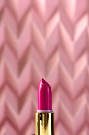 Lipstick on raised pink chevron. Product and make up concept