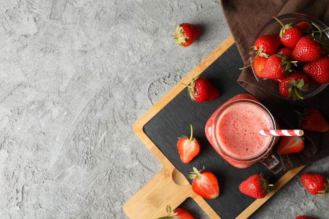 Composition with strawberry cocktail on gray table. Summer berry