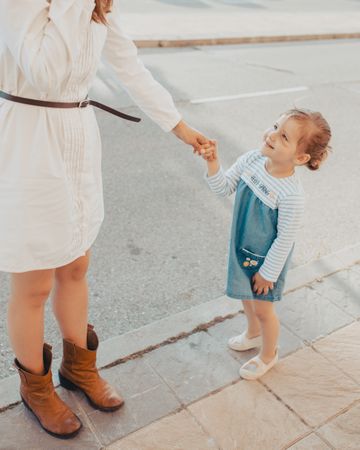 Mother and daughter standing on street