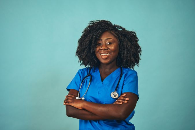 Portrait of confident and happy Black medical professional dressed in scrubs
