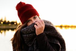 Charming woman in casual wear on shore of lake
