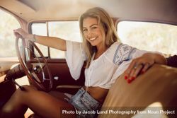 Portrait of beautiful woman traveling in a vintage car 0ynDR5