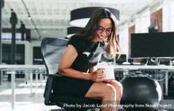 Black businesswoman laughing in a modern office bEDO14