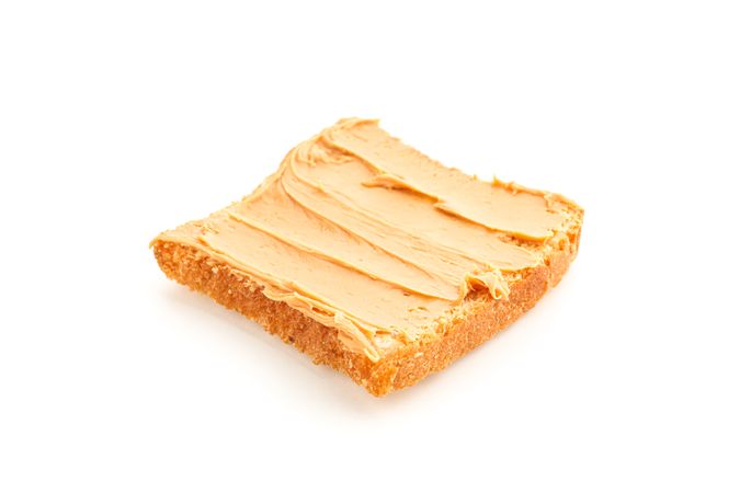 Peanut butter sandwich isolated on light background. A traditional product of American cuisine