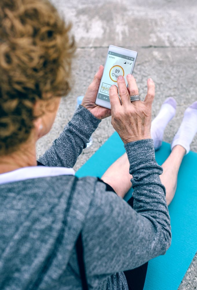 Back view of Mature woman using smartphone