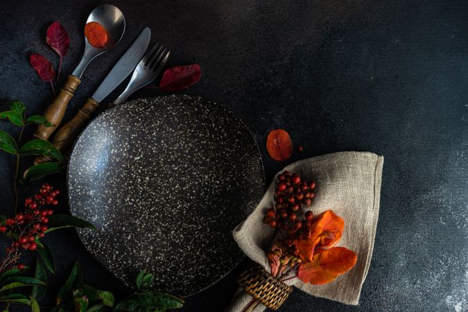 Top view of fall table setting with orange leaves