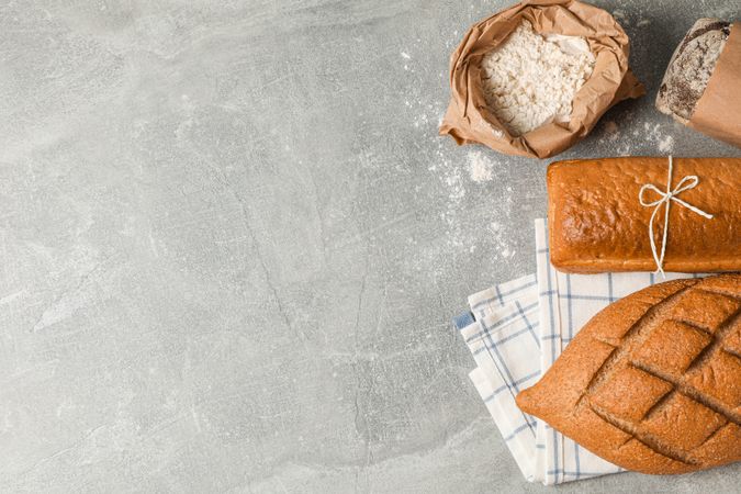 Bakery products composition on grey background, top view and space for text