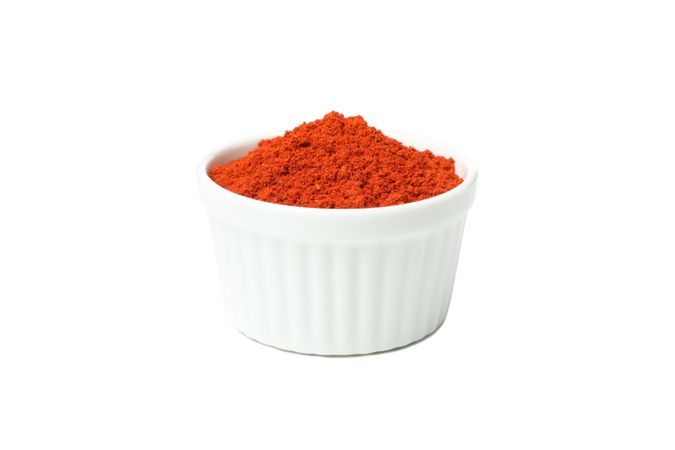 Bowl of pepper powder spice isolated on blank background