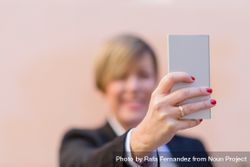 Woman holding phone with selective focus 4jPZ90