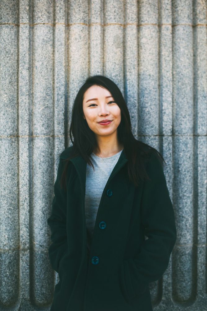 Asian woman near marble wall