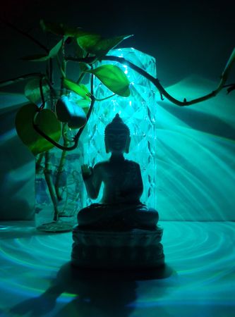 Buddha statue with a serene blue light backdrop