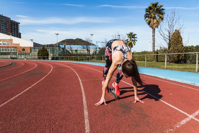 Unrecognizable young woman preparing to run