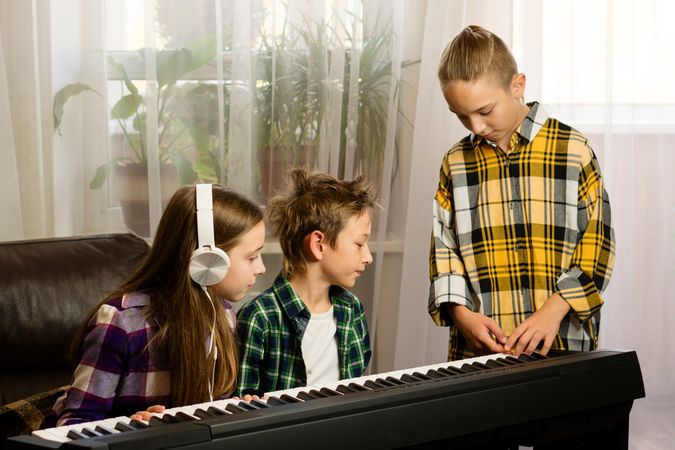 Focused Trio at Piano Lesson