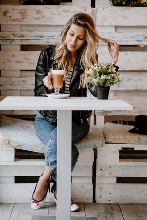 Woman drinking coffee from a glass