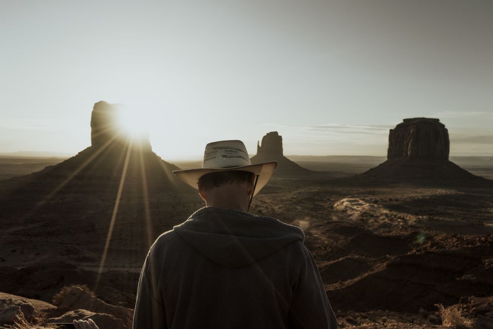 Man in hat looking at amazing structures in desert