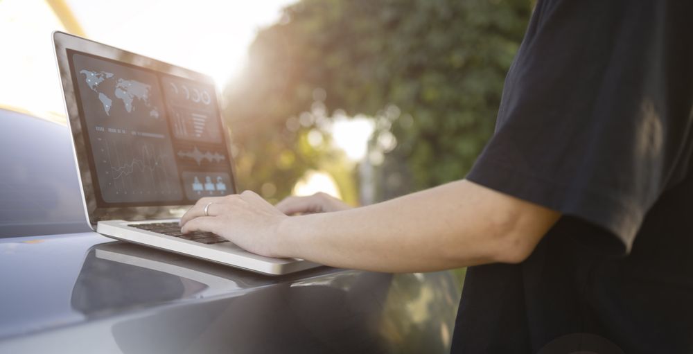 Remote Work in Nature: Laptop on Car Trunk