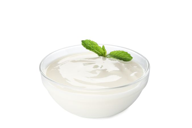 Bowl of sour cream yogurt isolated on blank background