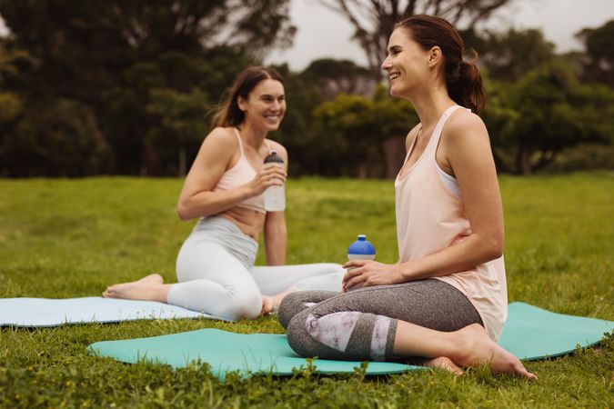 Cheerful women friends relaxing during a workout