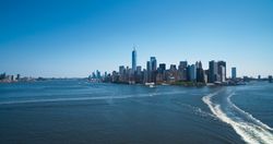 Aerial Shot of Manhattan Island with Office and Apartment Buildings. Hudson River Scenery with Yachts, Boats, One World Trade Center Skyscraper in the Middle of Skyline