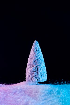Snowy Christmas tree on snow in vibrant bold gradient holographic colors