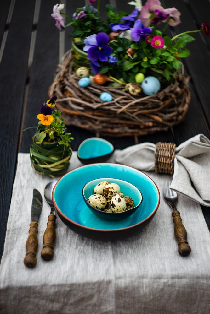 Easter table setting with teal plates and mini eggs