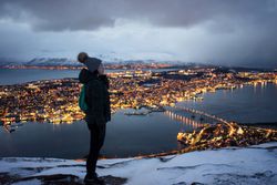 Joyful millennial woman enjoying view of night city