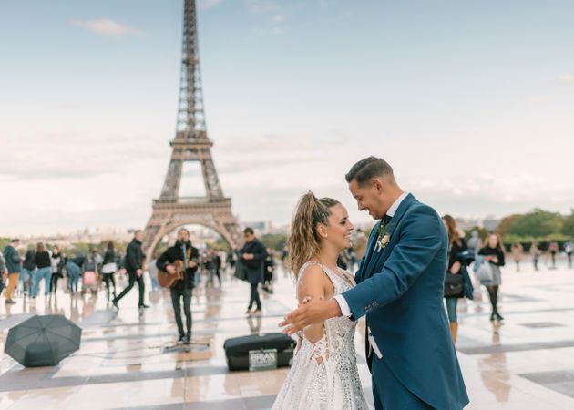 Happy newlyweds in wedding clothing dancing together