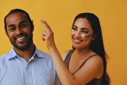 Woman putting beauty mask on male friend