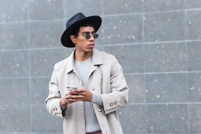 Stylish man with smartphone on street