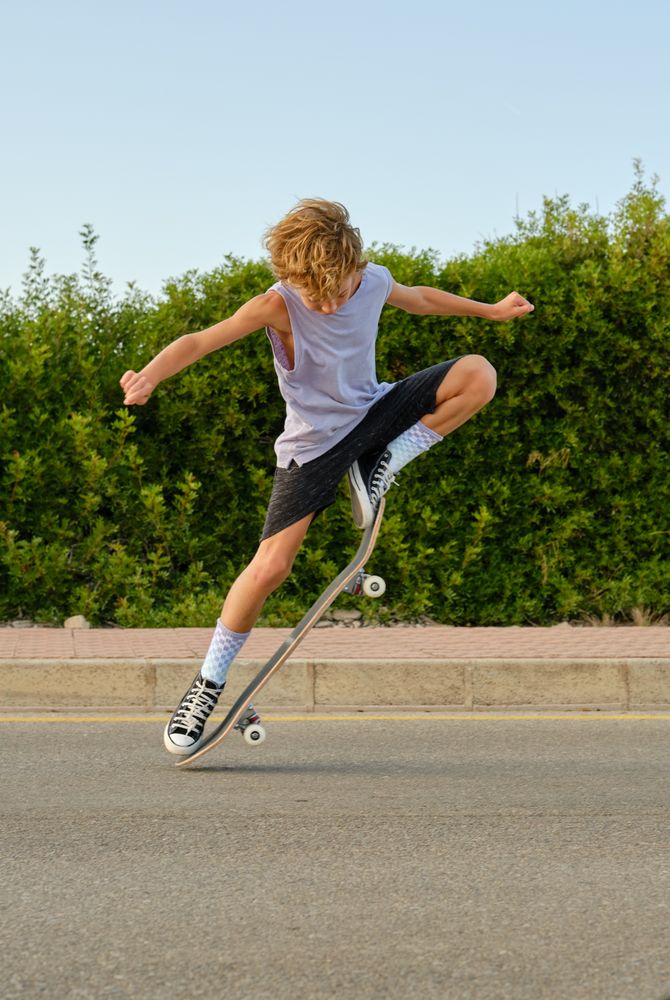 Brave boy jumping with skateboard