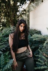 female standing near bushes