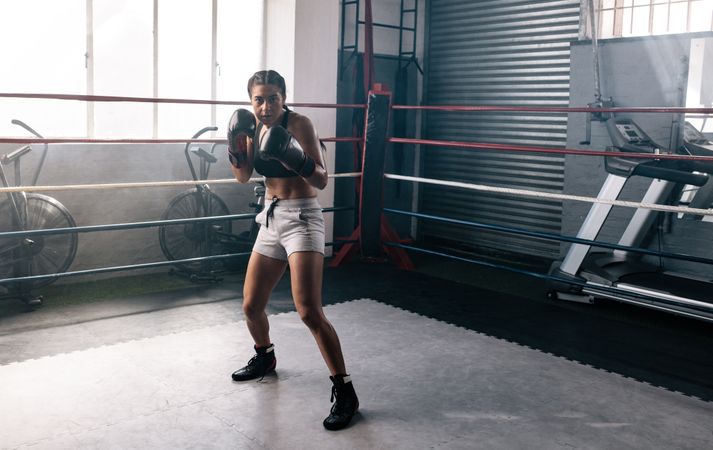 Female boxer practicing inside the ring