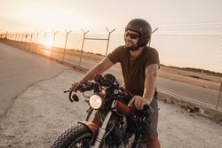 Strong man driving motorcycle